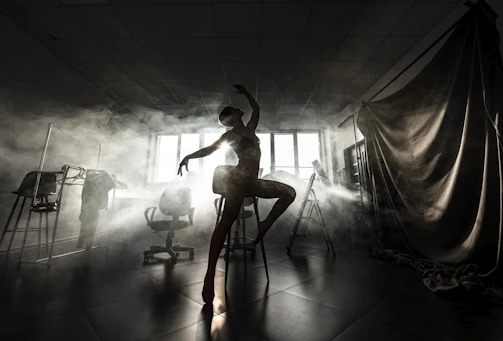 A graceful silhouette of a dancer demonstrating perfect posture under soft lighting.