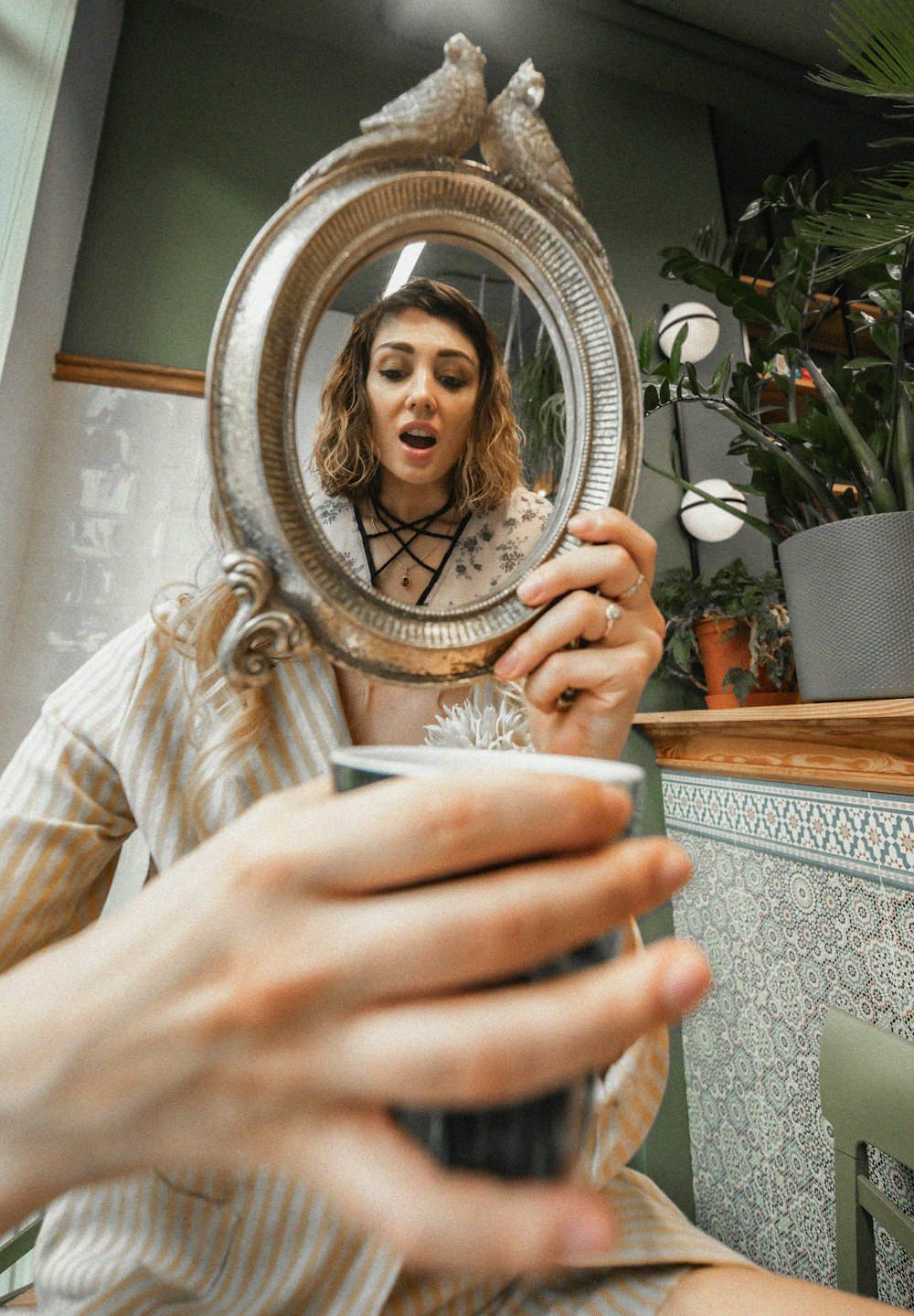 a woman taking a picture of herself in a mirror