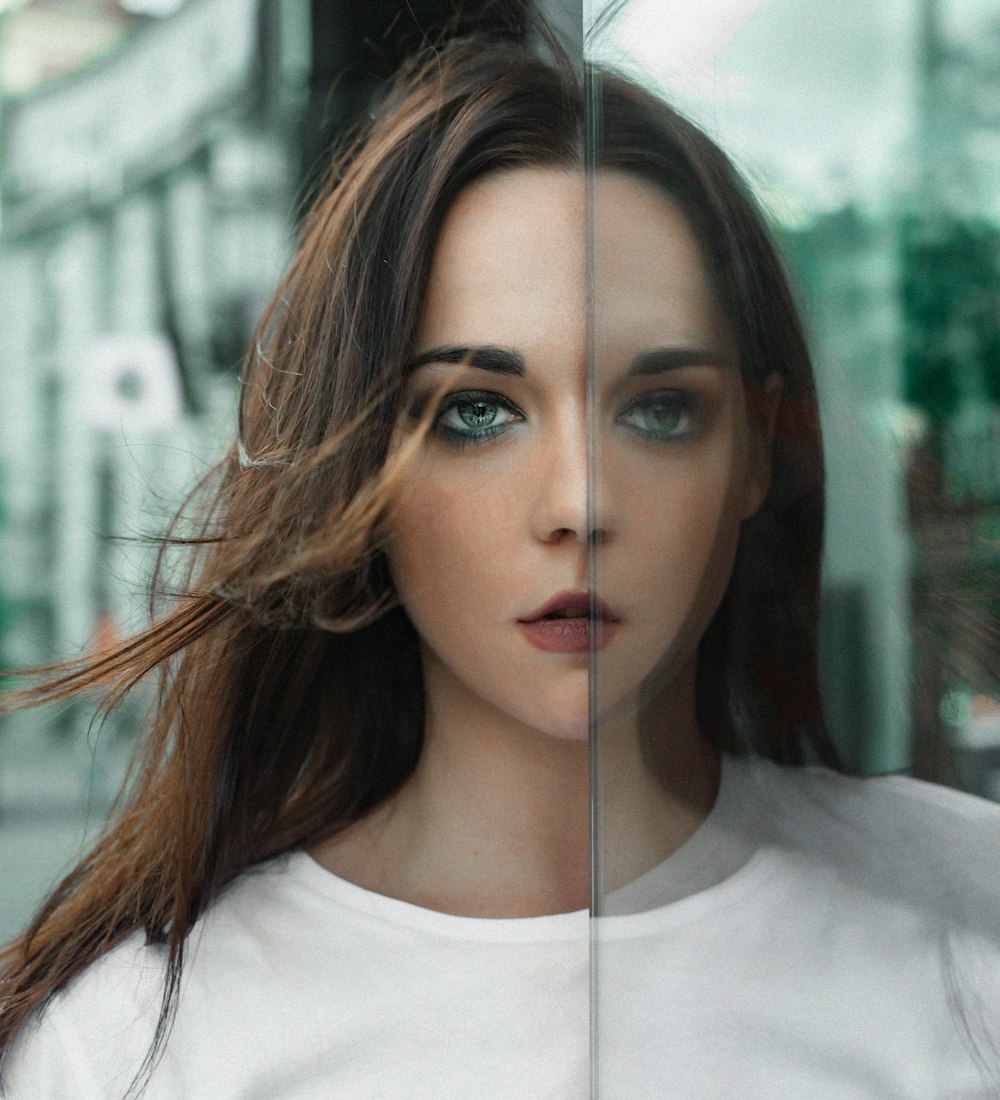 a woman's face is reflected in a glass window