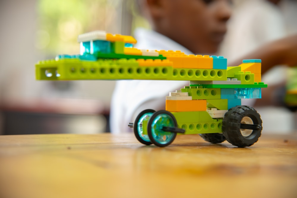 a toy car made out of legos sitting on a table