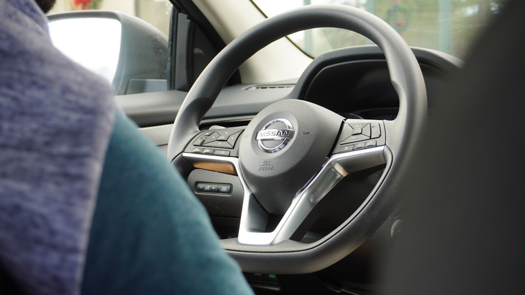 a steering wheel of a car with a blue blanket,