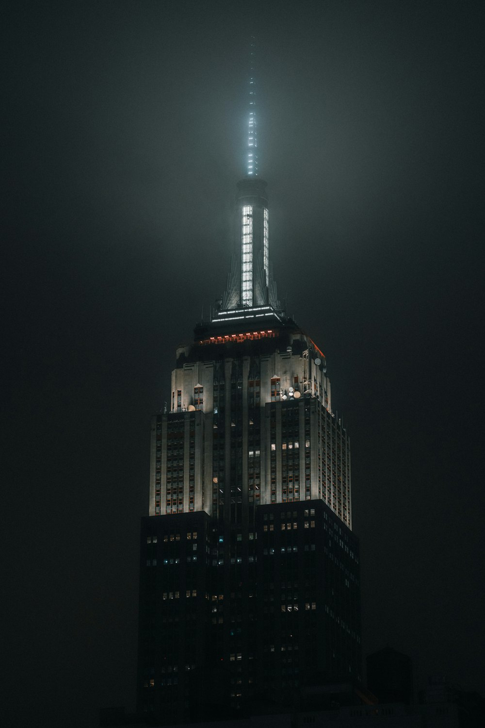 a tall building lit up in the night sky