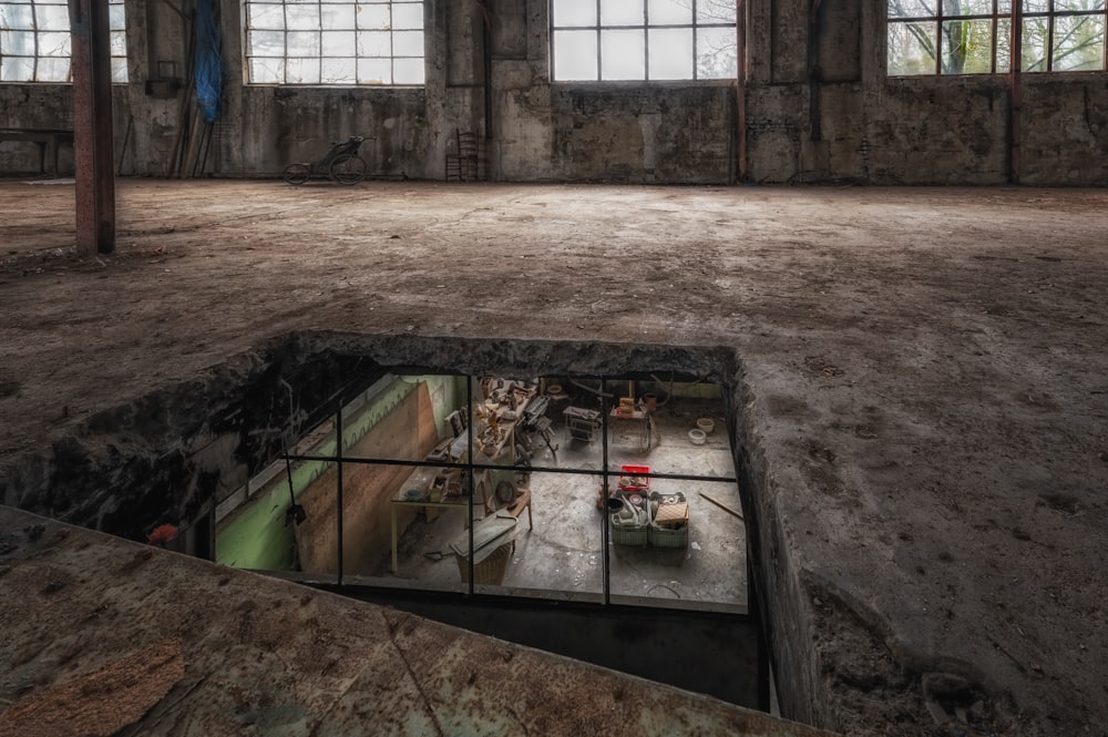 an empty room with a large window and a sink