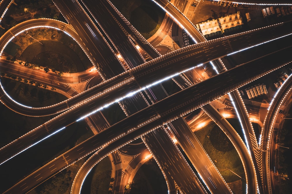 an aerial view of a highway intersection at night