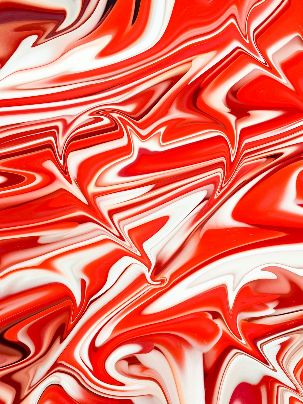 a close up of a red and white swirled background