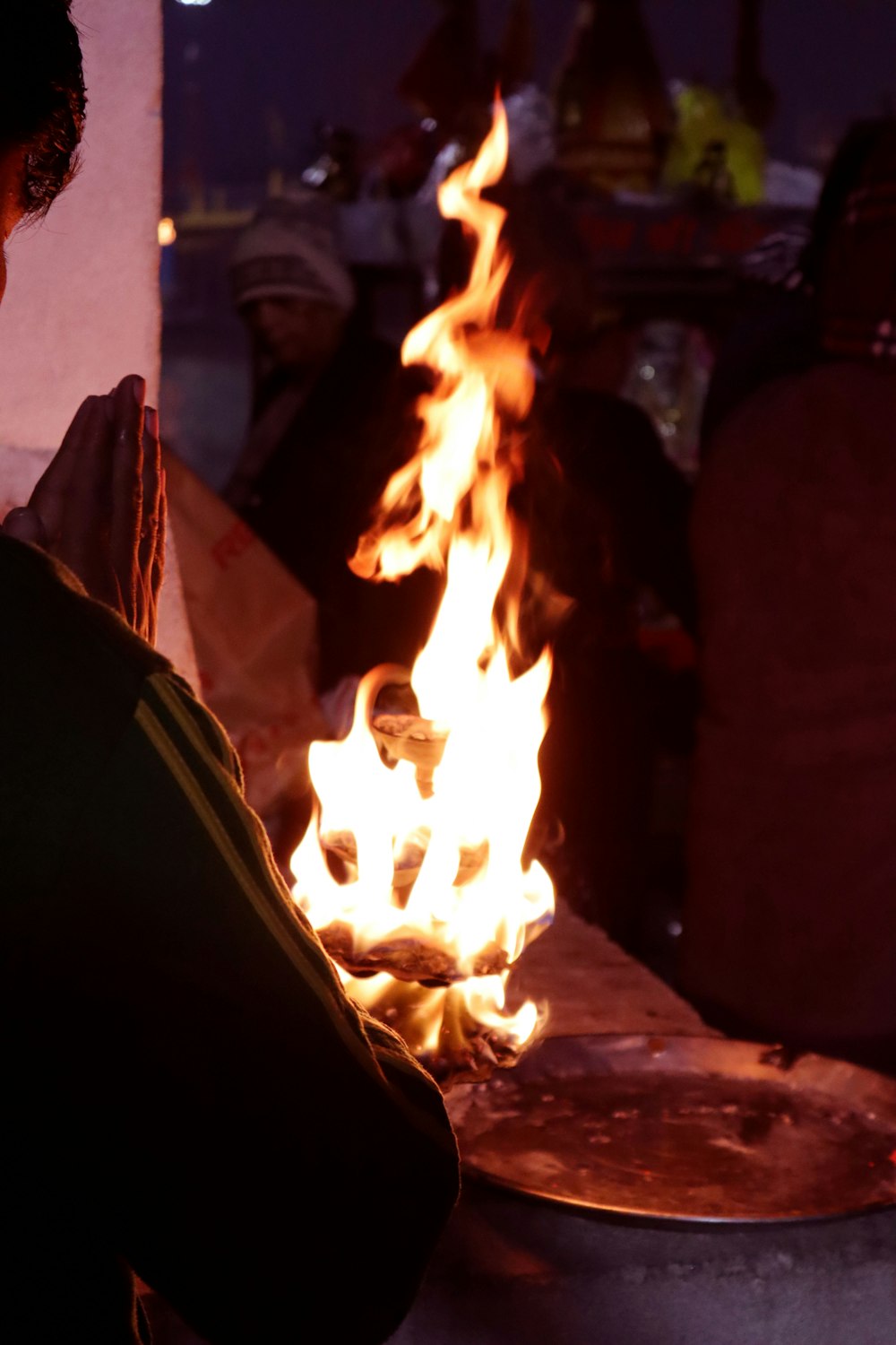 a man standing in front of a fire pit