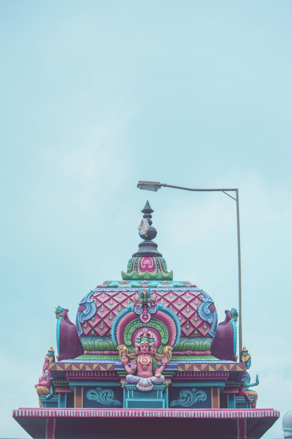 a colorfully decorated building with a street light on top of it