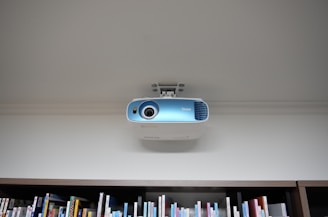 a projector mounted on the ceiling of a library