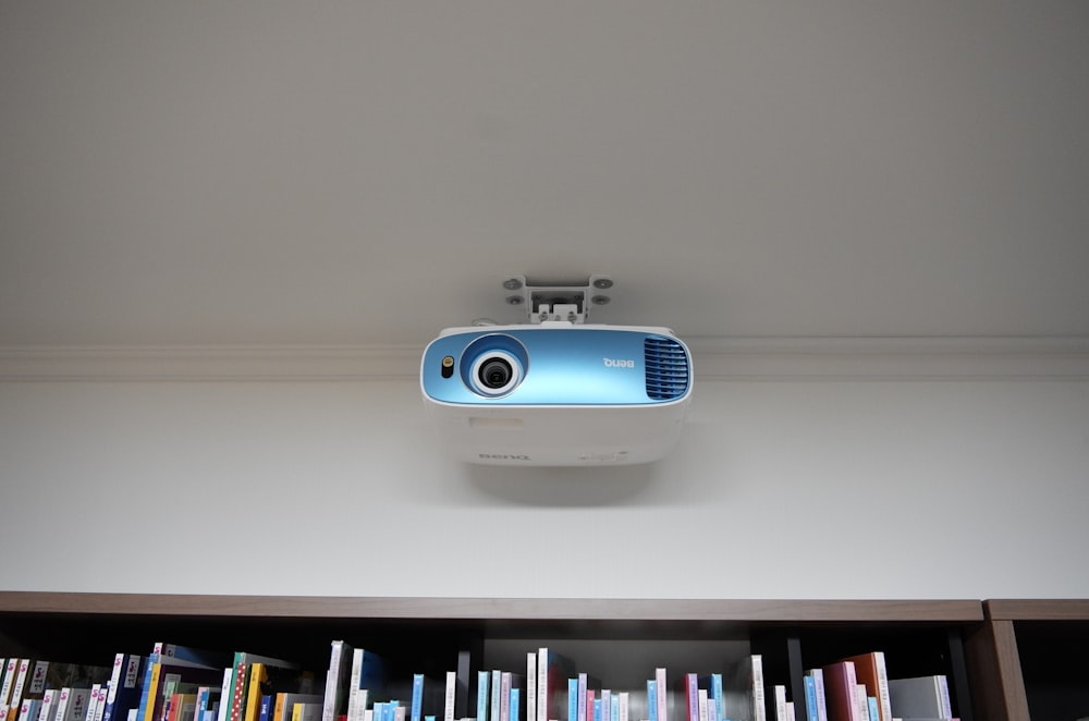a projector mounted on the ceiling of a library