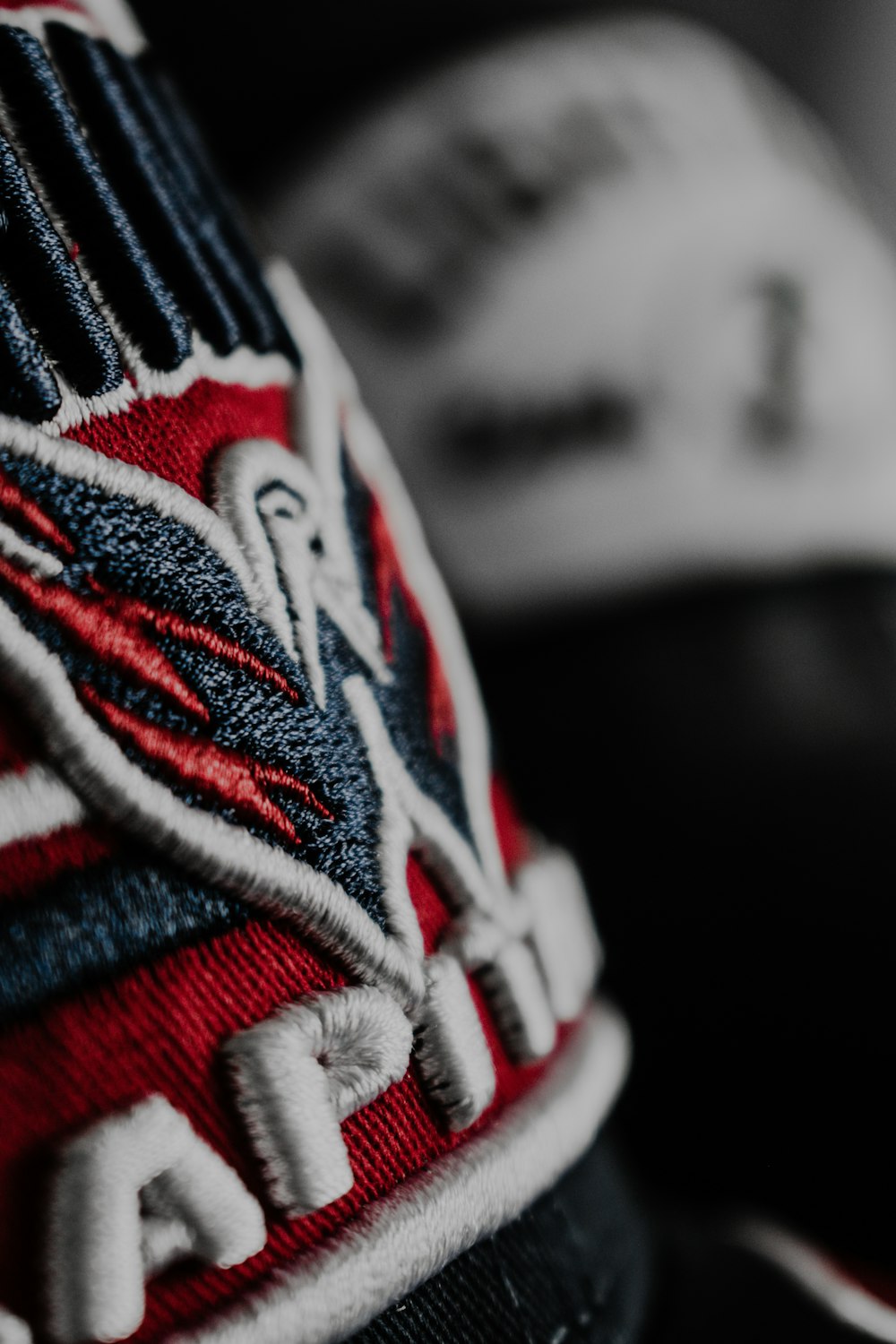 a close up of a baseball cap with a logo on it