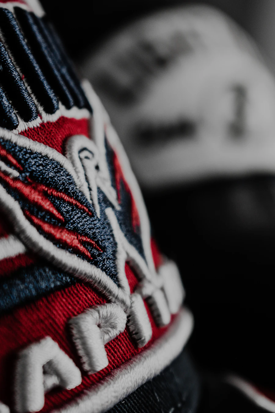 Close-up of a raised embroidered logo on a baseball cap
