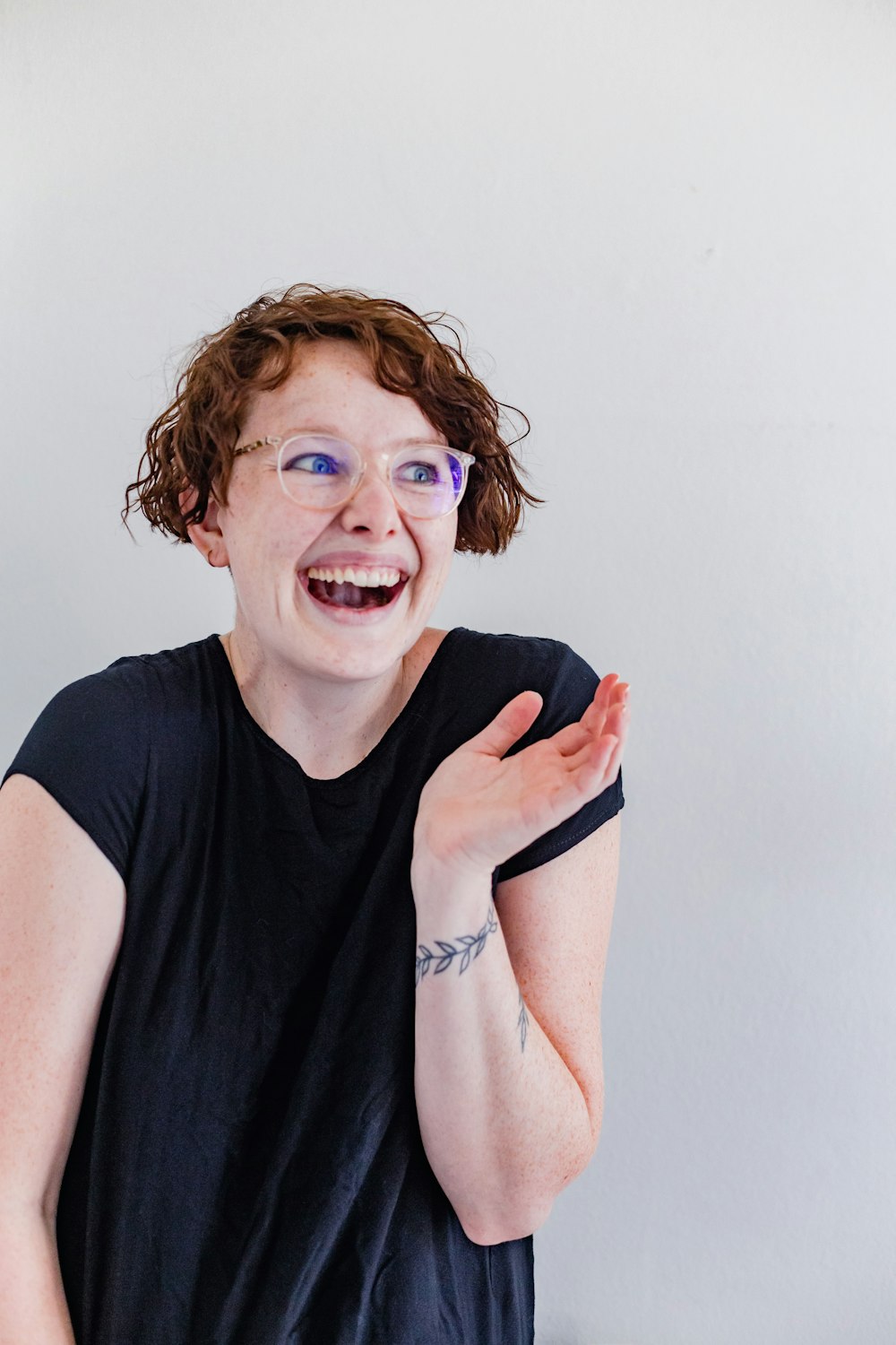 a woman with glasses making a funny face