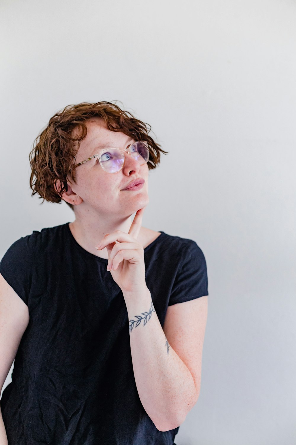 a woman wearing glasses and a black shirt