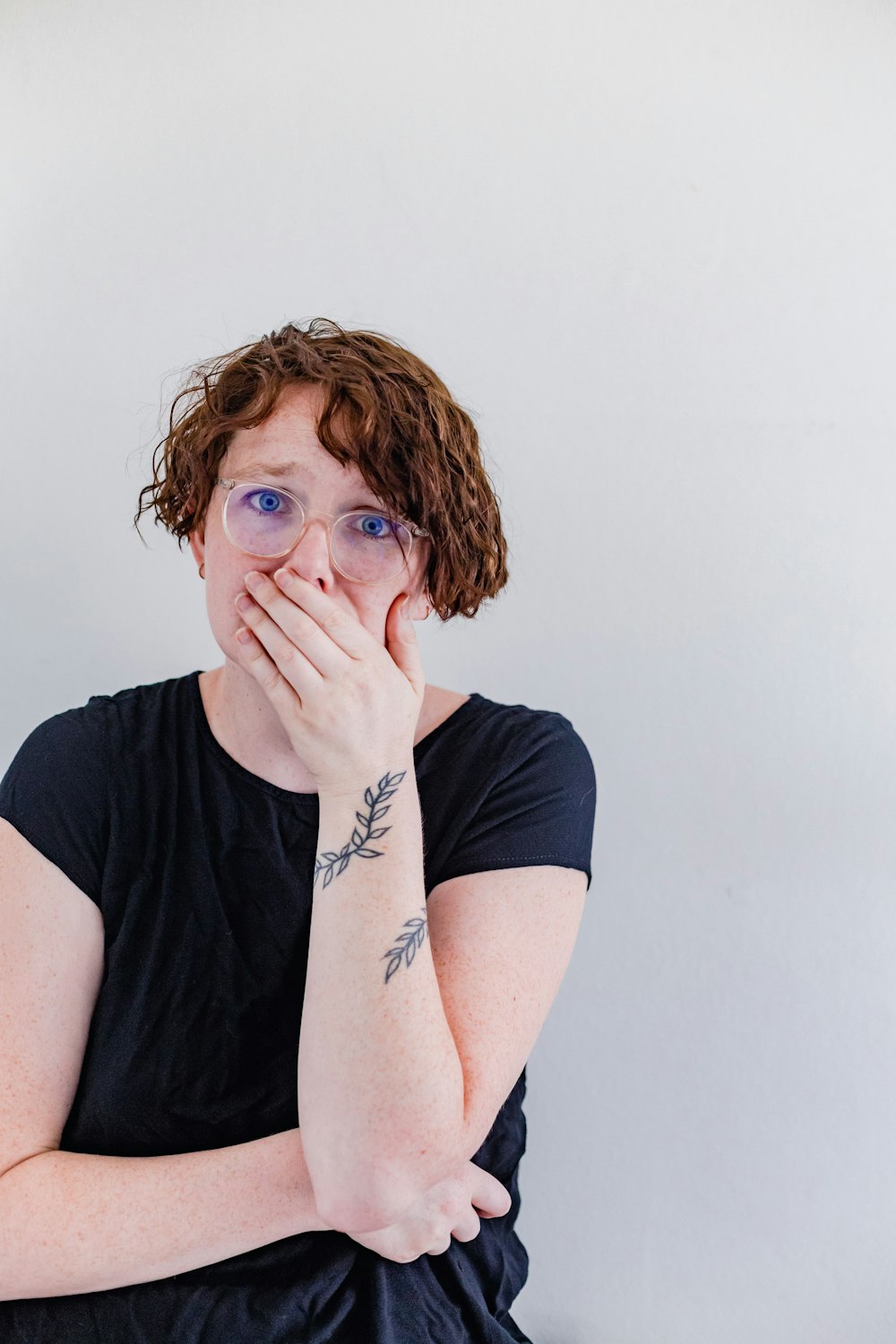 a woman covers her mouth with her hands