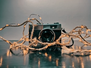 A cozy photo lab workspace with vintage cameras and prints drying on a line.