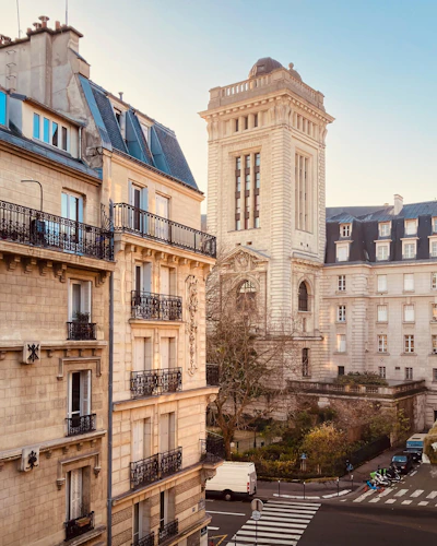 a tall building with a clock tower next to other buildings