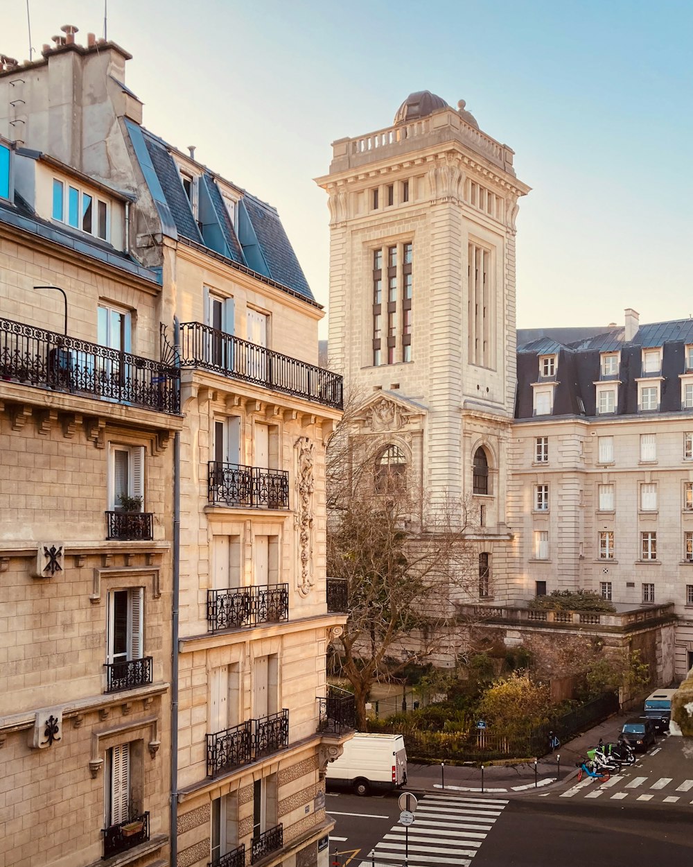 a tall building with a clock tower next to other buildings