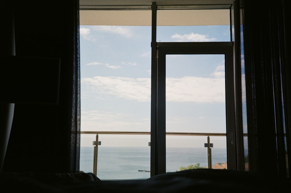 a bedroom with a view of the ocean