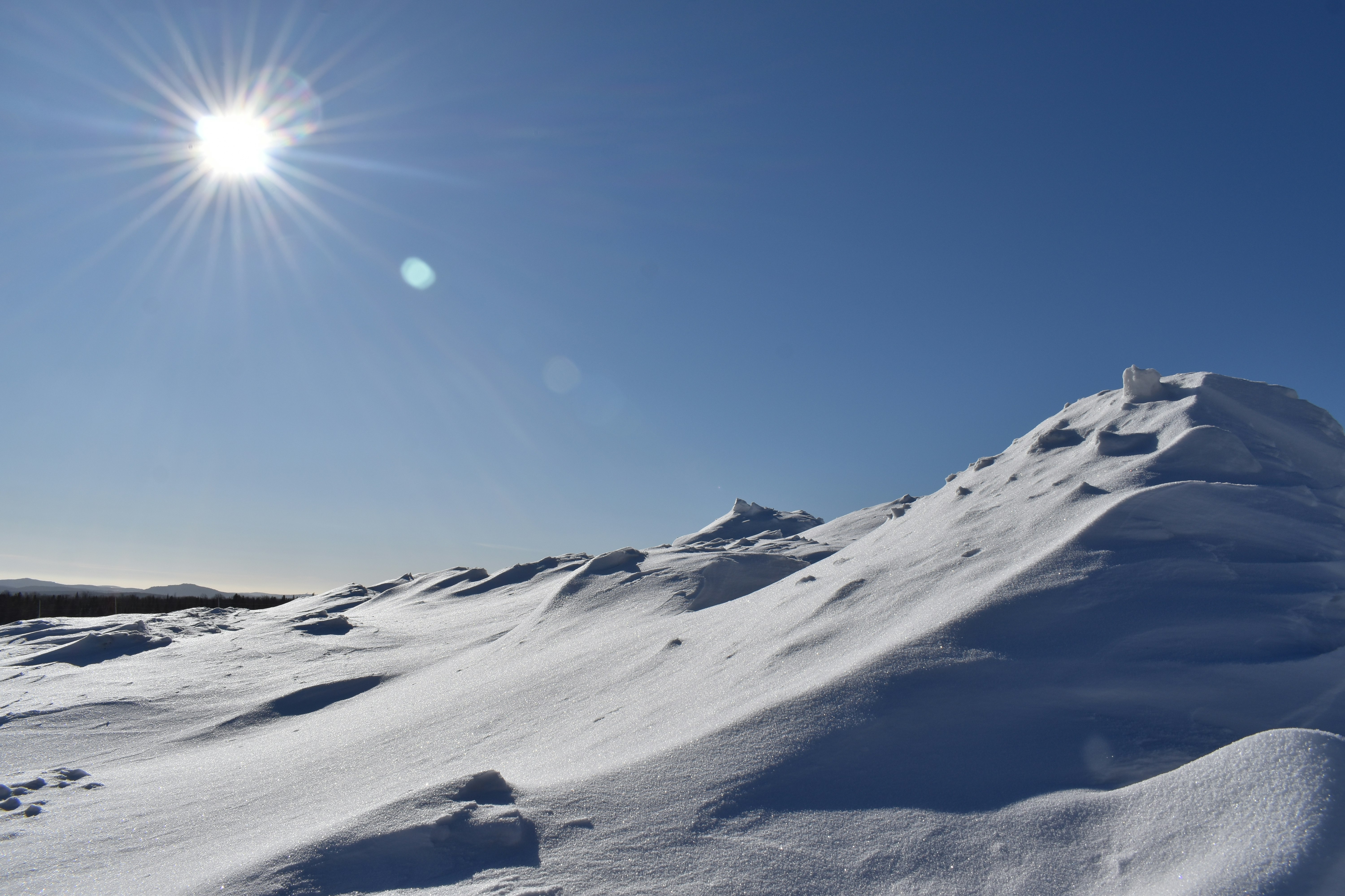 A snowdrift under a blue sky, Sainte-Apolline, Québec, Canada