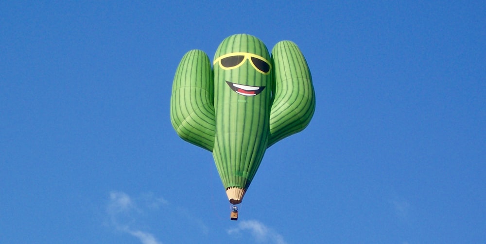 a large green balloon with a smiling face