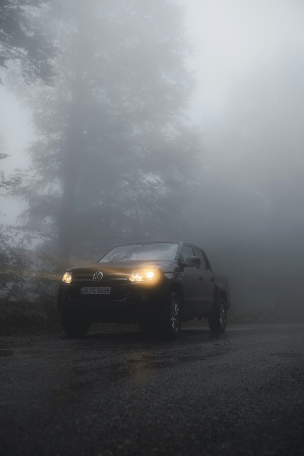 a car driving down a road in the fog