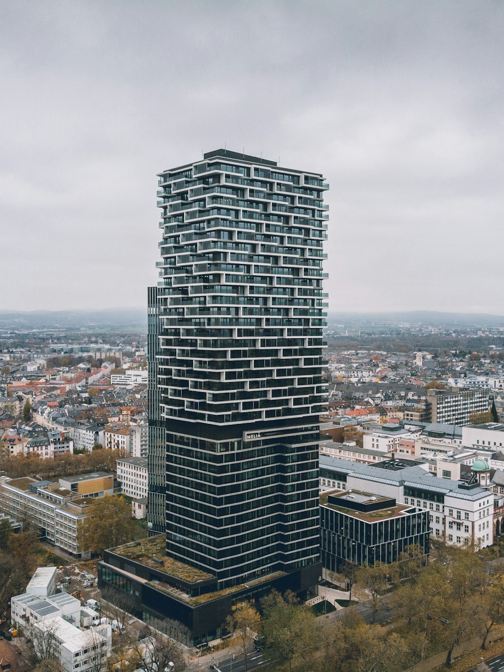 an aerial view of a tall building in a city