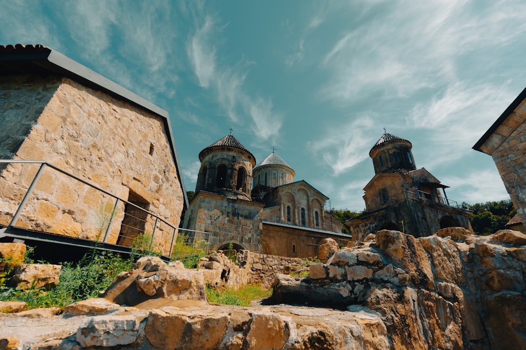 a stone building with two towers on top of it,