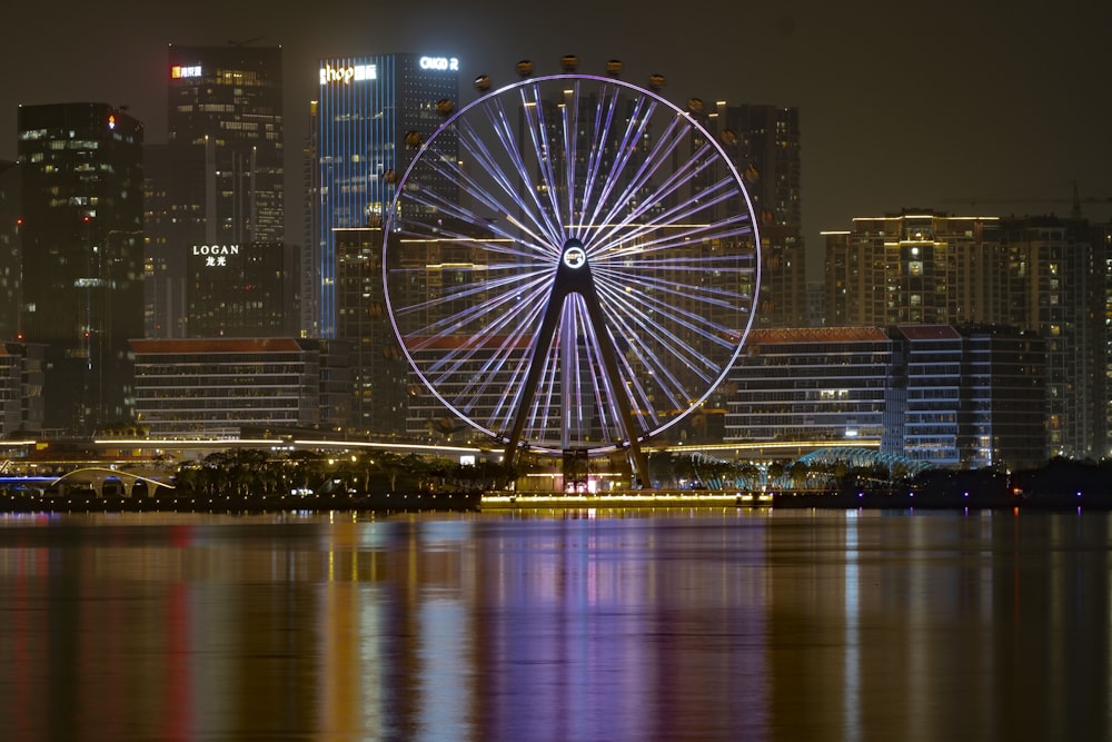 a large ferris wheel sitting in the middle of a city