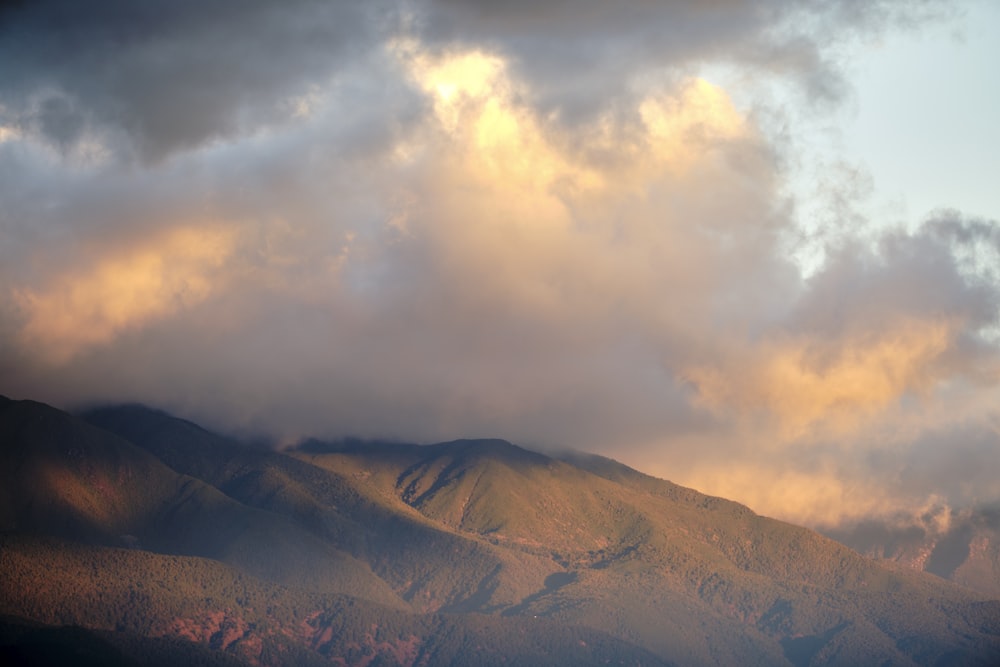 a view of a mountain range with clouds in the sky