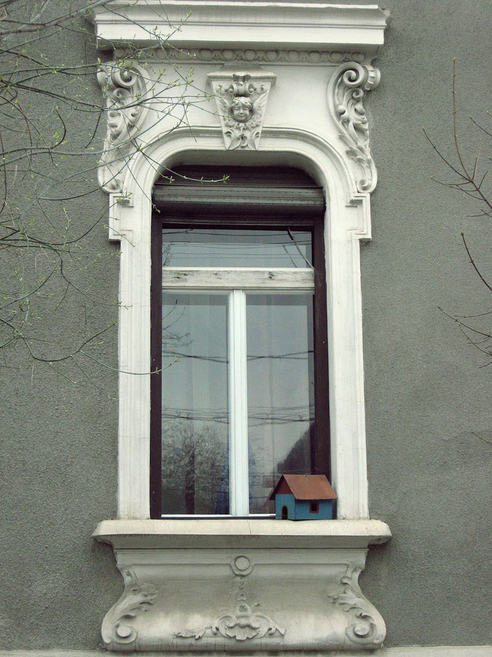 a window with a bird house in the window