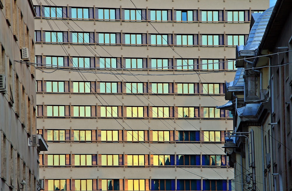 a tall building with lots of windows next to a street