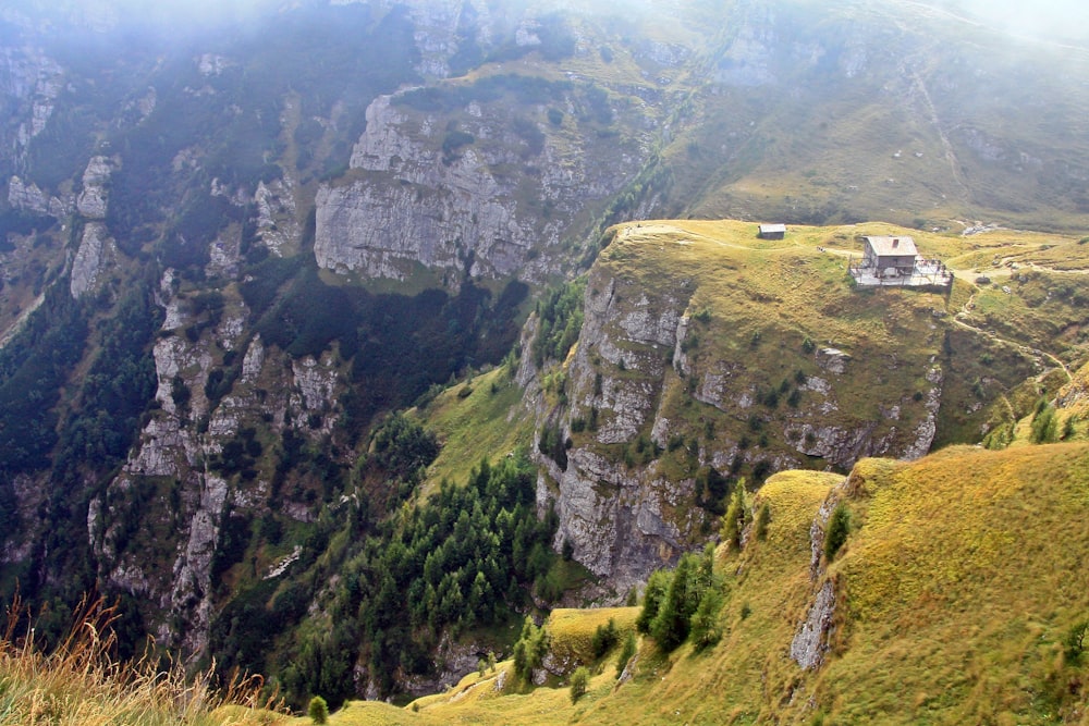 a view of a mountain with a house in the middle of it