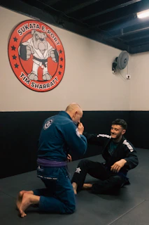 a man in a blue kimono and another man in a black kimono