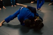 a person in a blue shirt is doing a trick