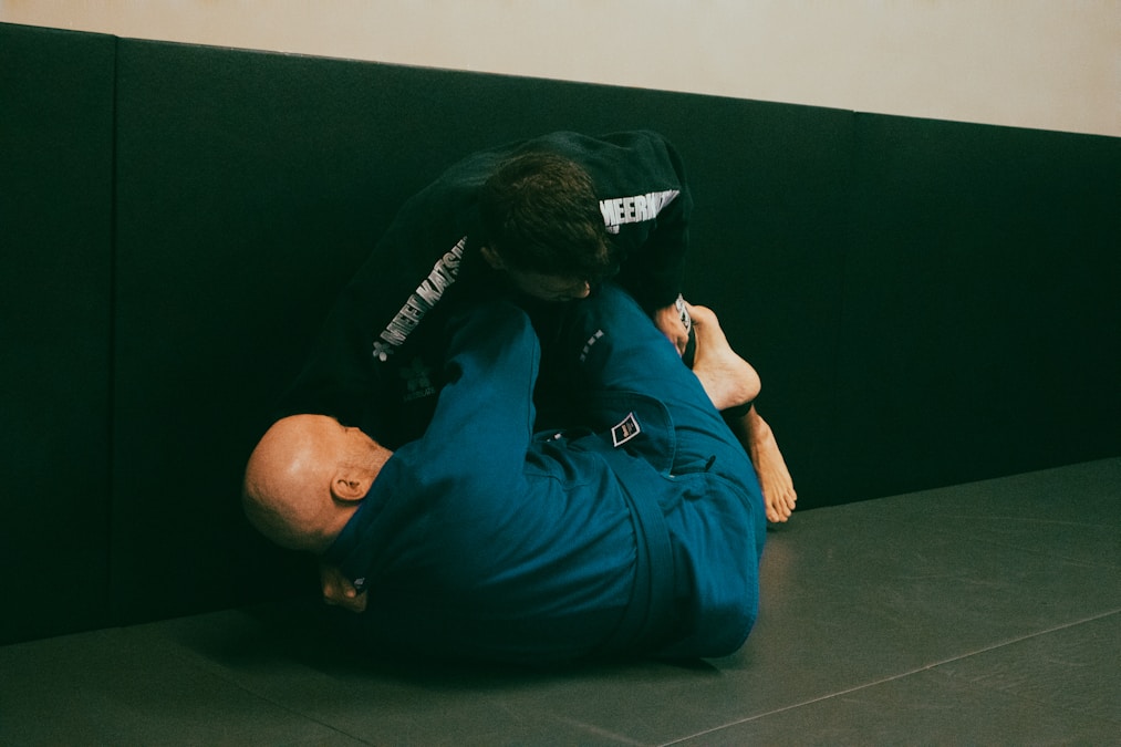 BJJ practitioner executing a grappling technique during a professional jiu-jitsu match