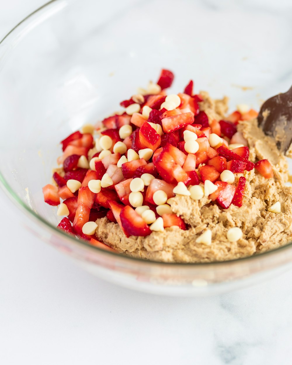 a bowl filled with oatmeal and strawberries