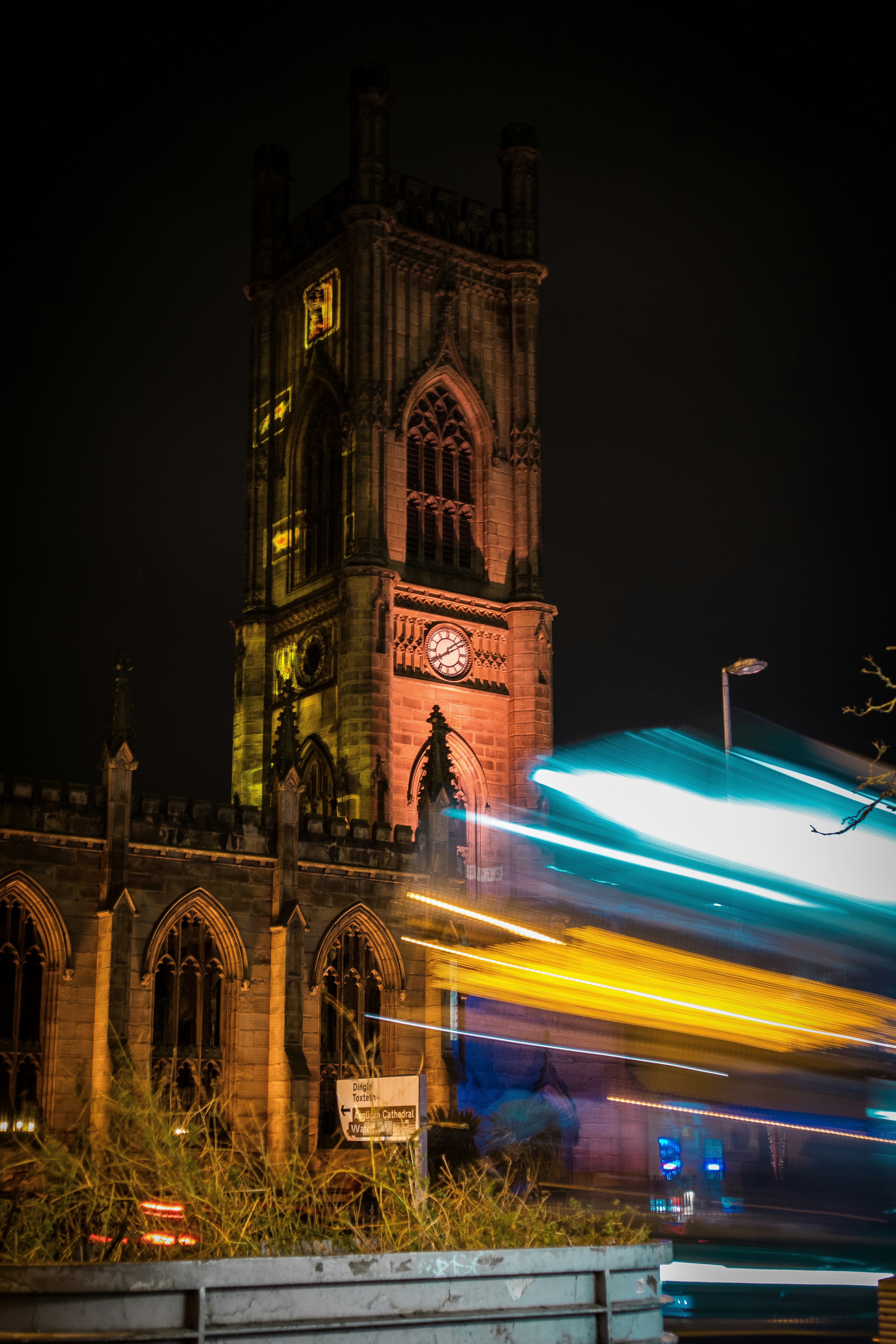 a large clock tower towering over a city at night