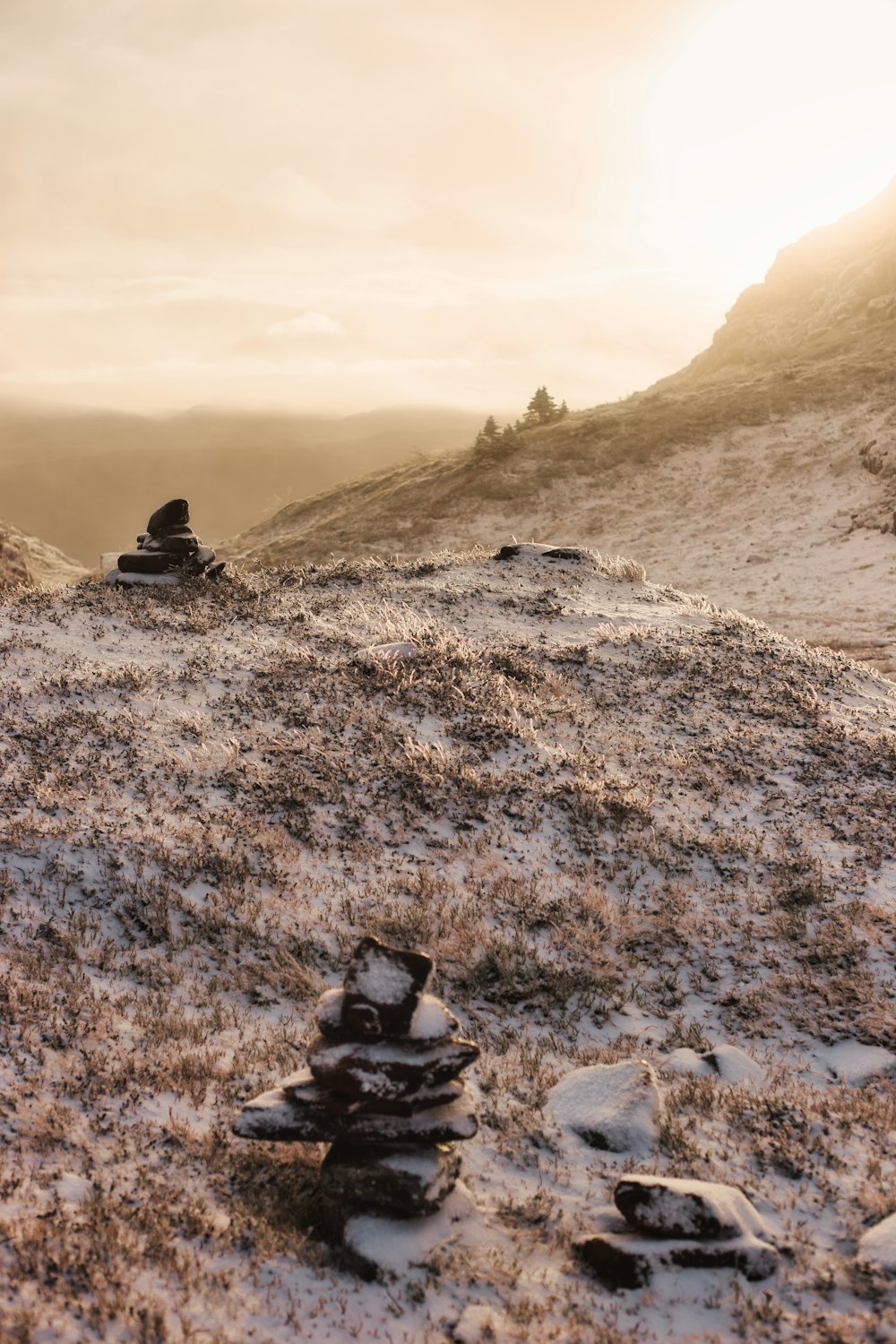 a pile of rocks sitting on top of a snow covered hillside