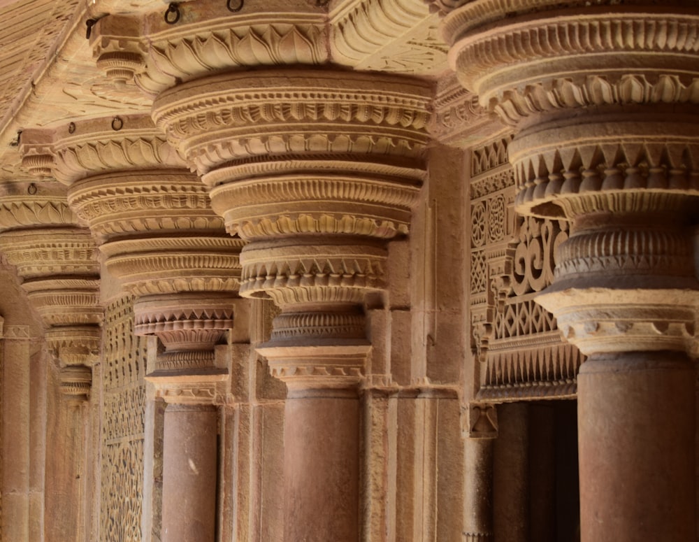 a row of pillars with carvings on them