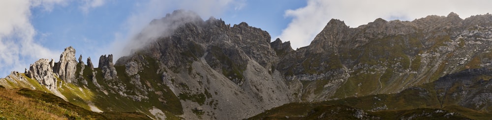 a group of mountains with clouds in the sky