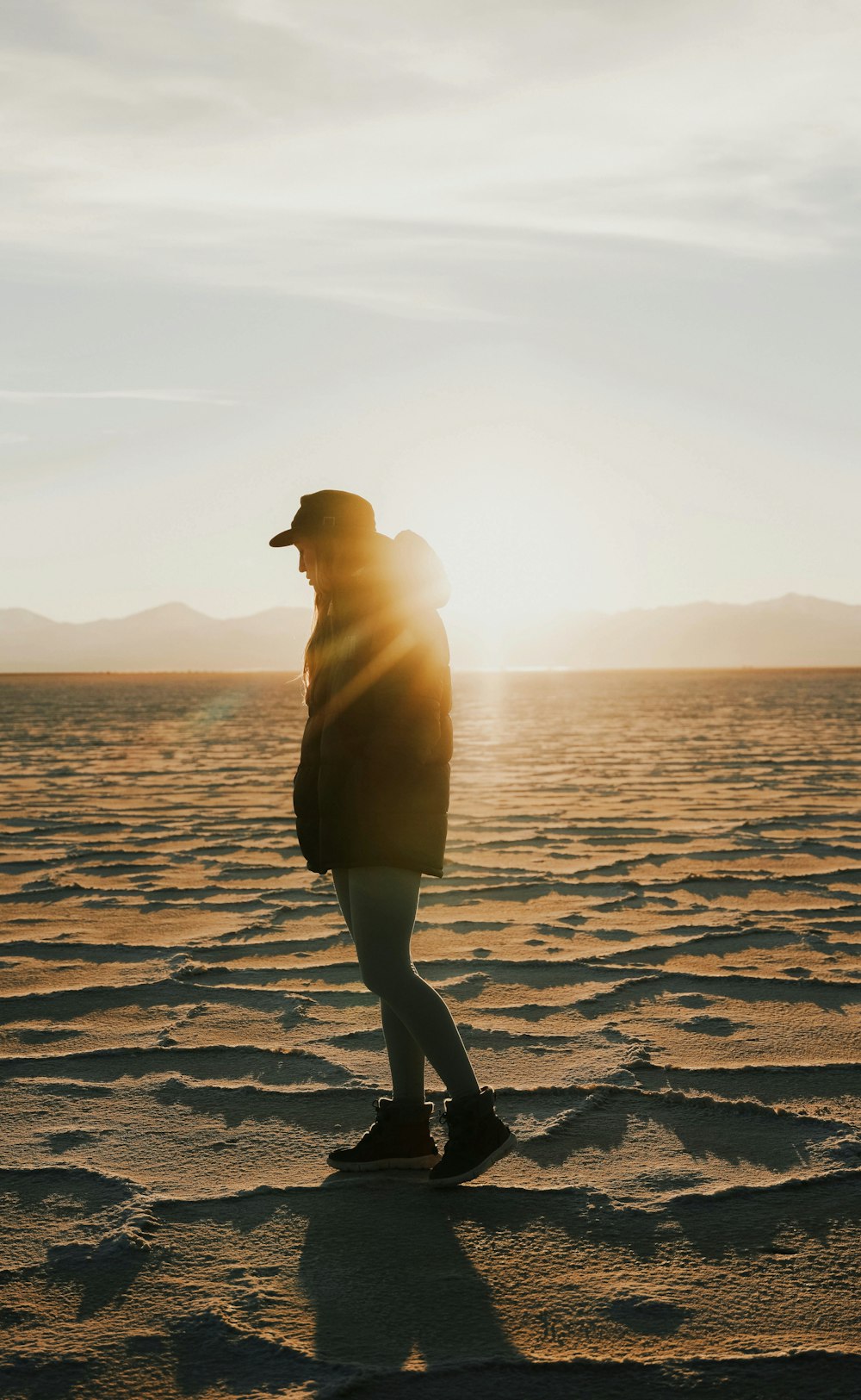 a person standing in the middle of a desert