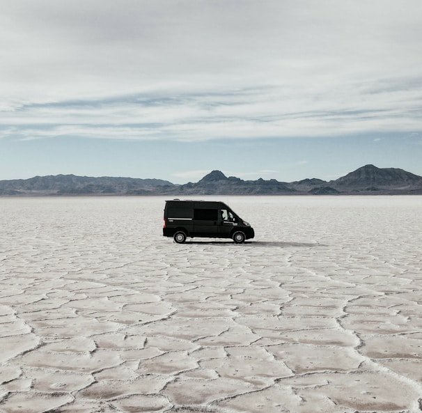 a van is parked in the middle of the desert