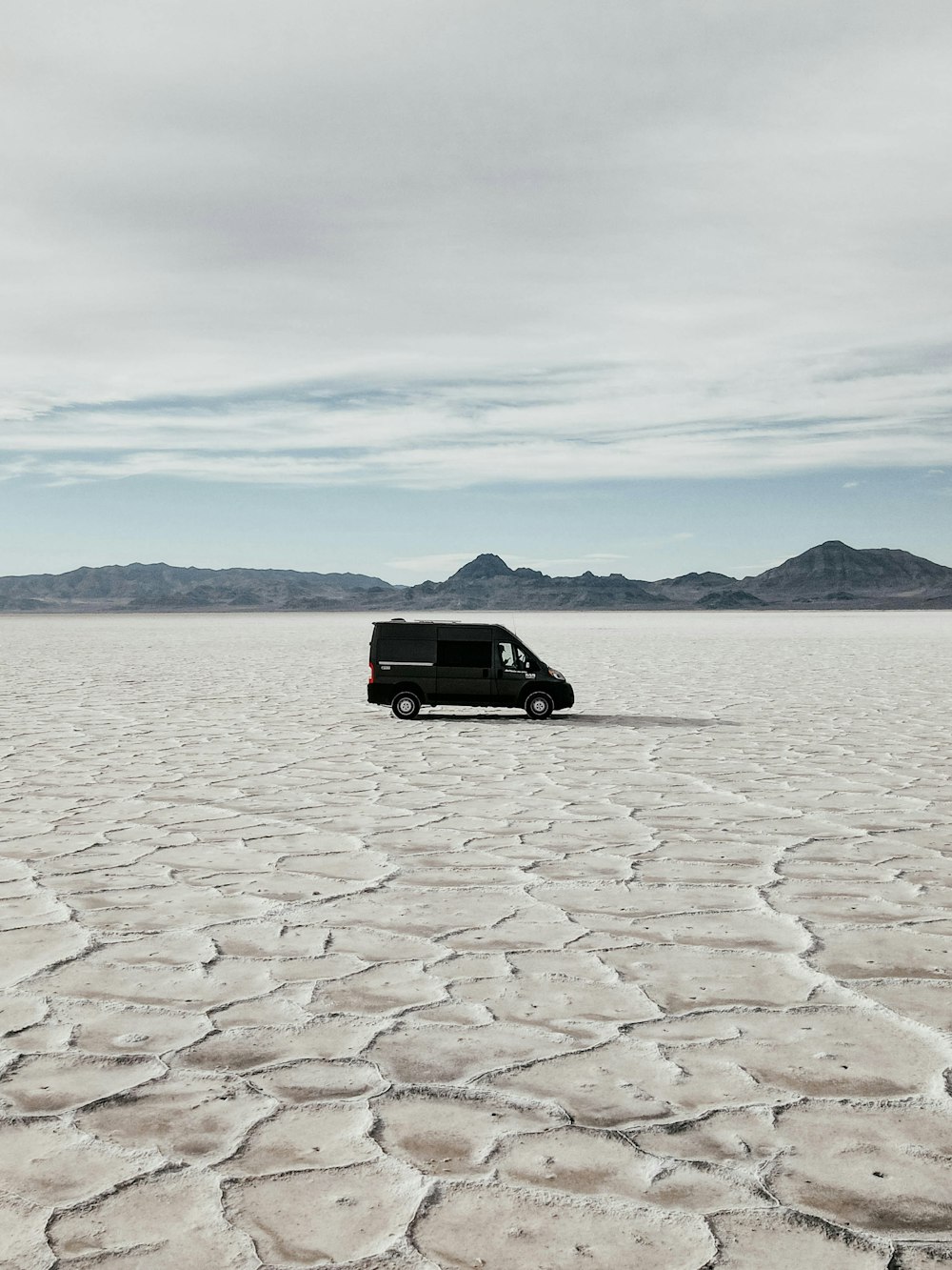 a van is parked in the middle of the desert