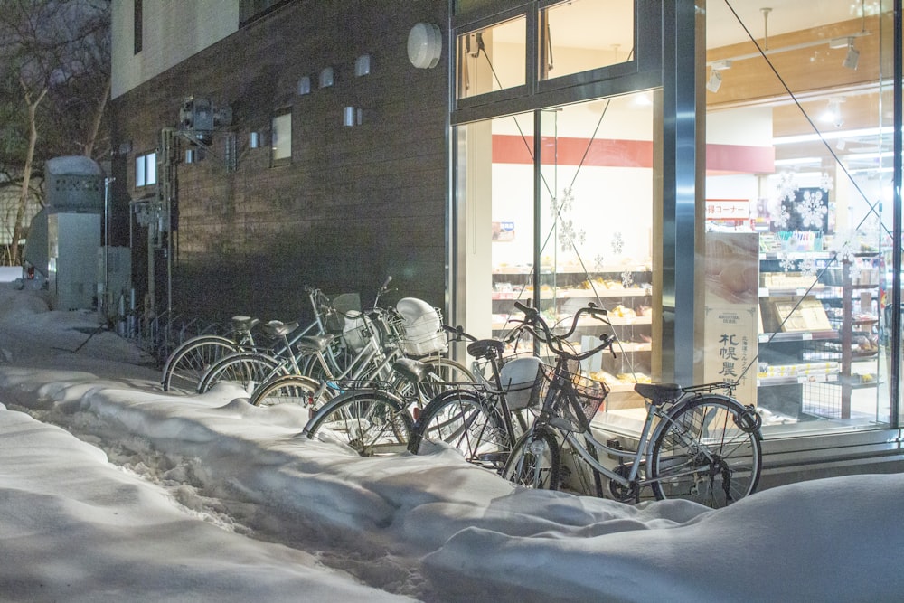 a row of bicycles parked in front of a store