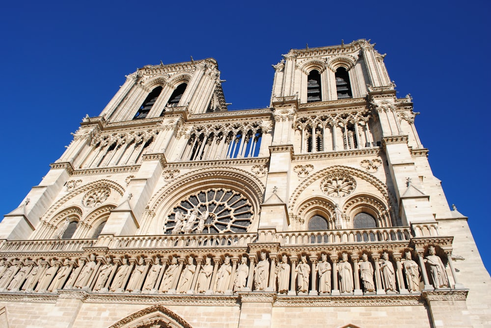 a very tall cathedral with a massive clock on it's side