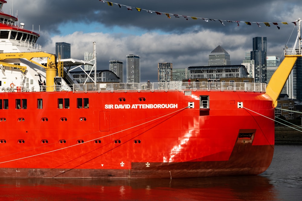 a large red and white boat in a body of water