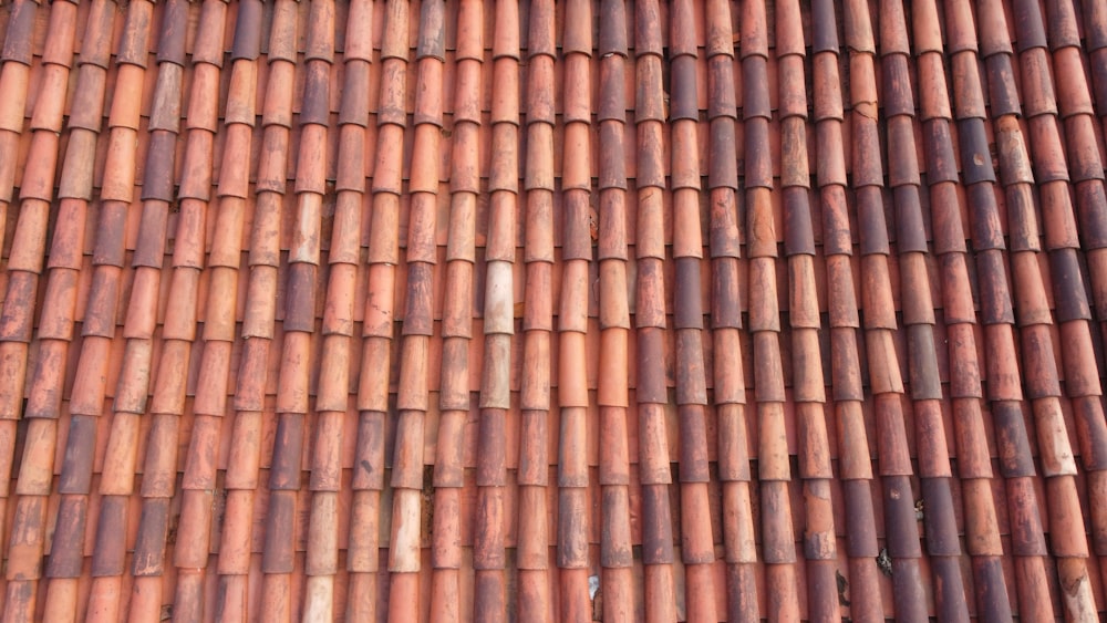 a close up of a roof made of red tiles
