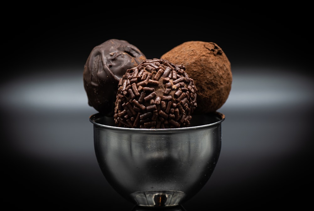 un bol en métal rempli de différents types de chocolats
