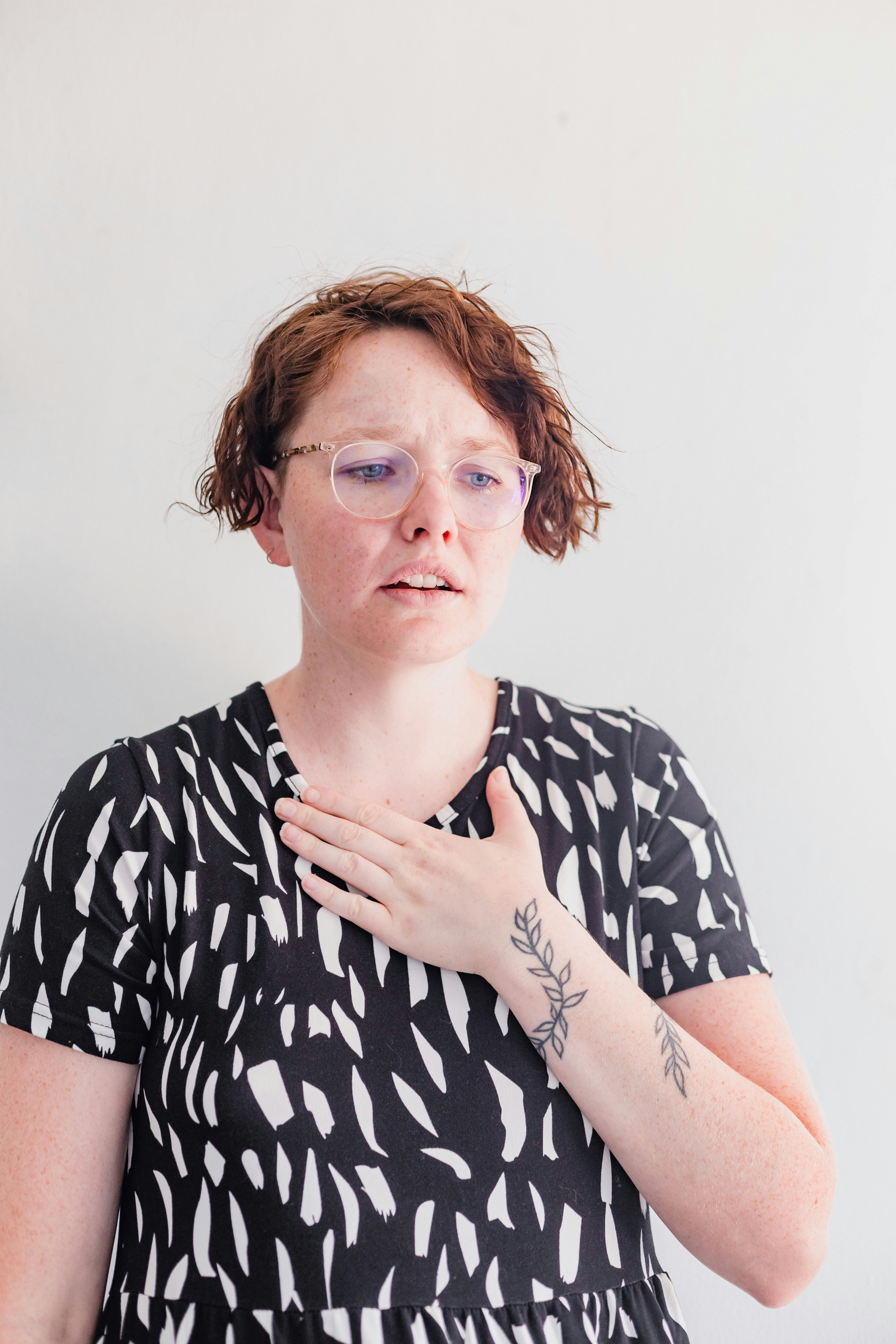 A person looking overwhelmed by a pile of small pebbles that appear to form a giant mountain, symbolizing small problems feeling huge.