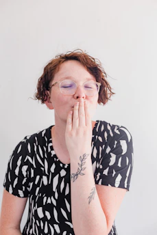 a woman covers her mouth with her hands